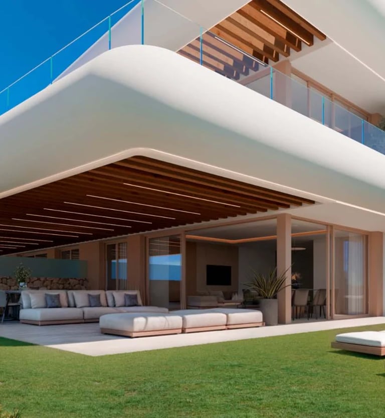 Modern multi-level beach house with curved white exterior, wooden elements, and open terrace with outdoor seating overlooking the sea