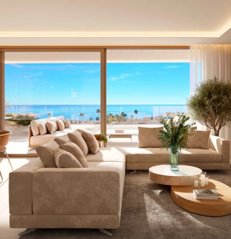 Luxury modern living room with beige furniture, floor-to-ceiling windows overlooking ocean and palm trees, and natural daylight