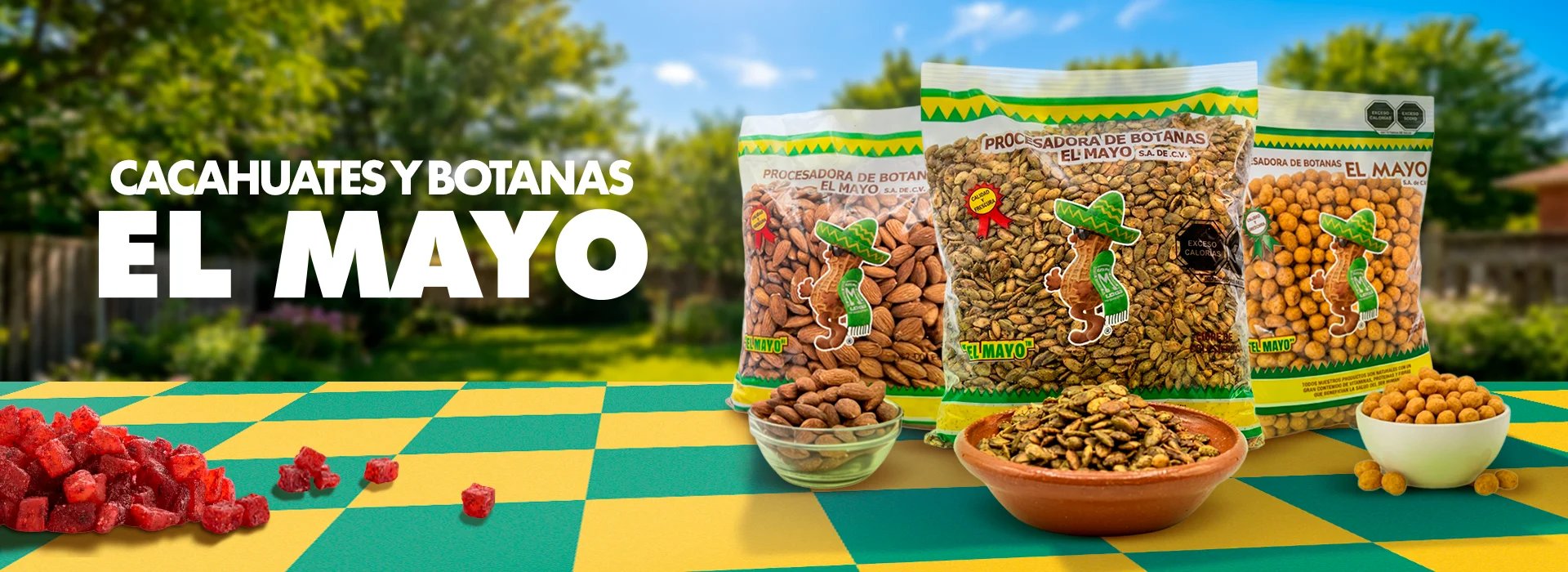 Product display of El Mayo peanuts and legumes in clear packaging on colorful checkered surface with fresh produce