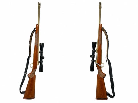 Two rifles with wooden stocks, black scopes, and slings shown from side view against white background