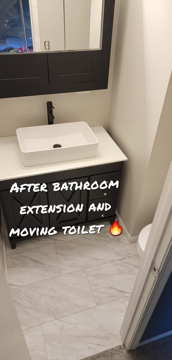 Modern bathroom with white rectangular sink on black vanity, marble flooring, and mirror cabinet above