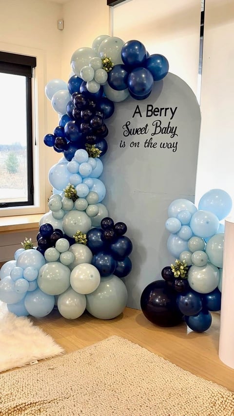 Baby shower balloon arch with navy, white, and light blue balloons