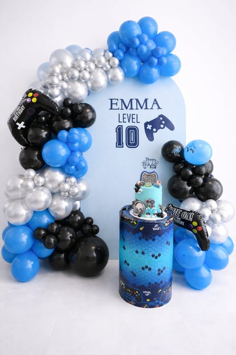 Birthday party with blue, black, and silver balloon arch, Emma Level 10 gaming sign