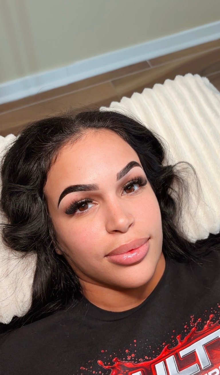 Client result: full lash extension set with balanced brow shape, white pillow background