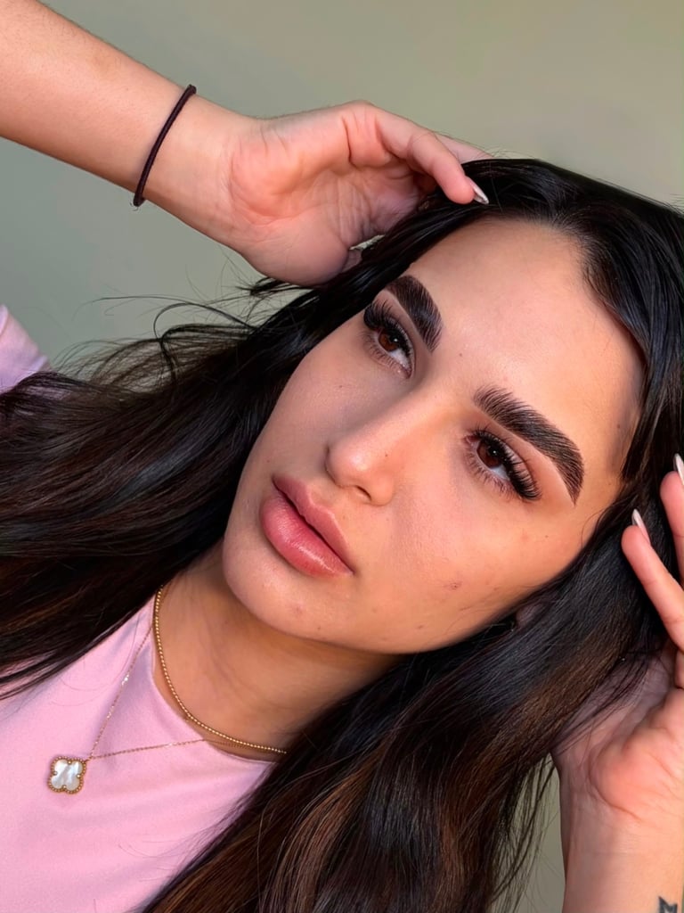 Client result: bold brows and natural lashes, portrait against neutral background