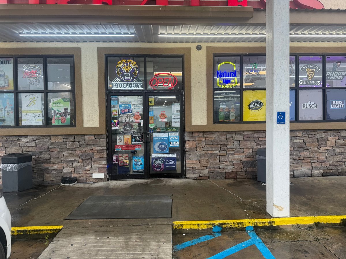 Storefront entrance with brick facade, glass doors and business signage, welcoming entrance