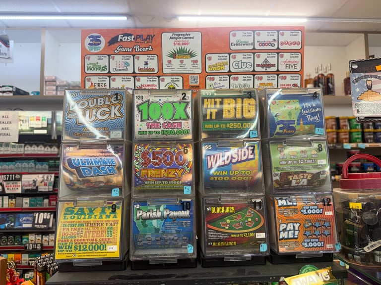 Display of scratch-off lottery tickets in a convenience store window, with multiple colorful ticket boxes and games organized in rows