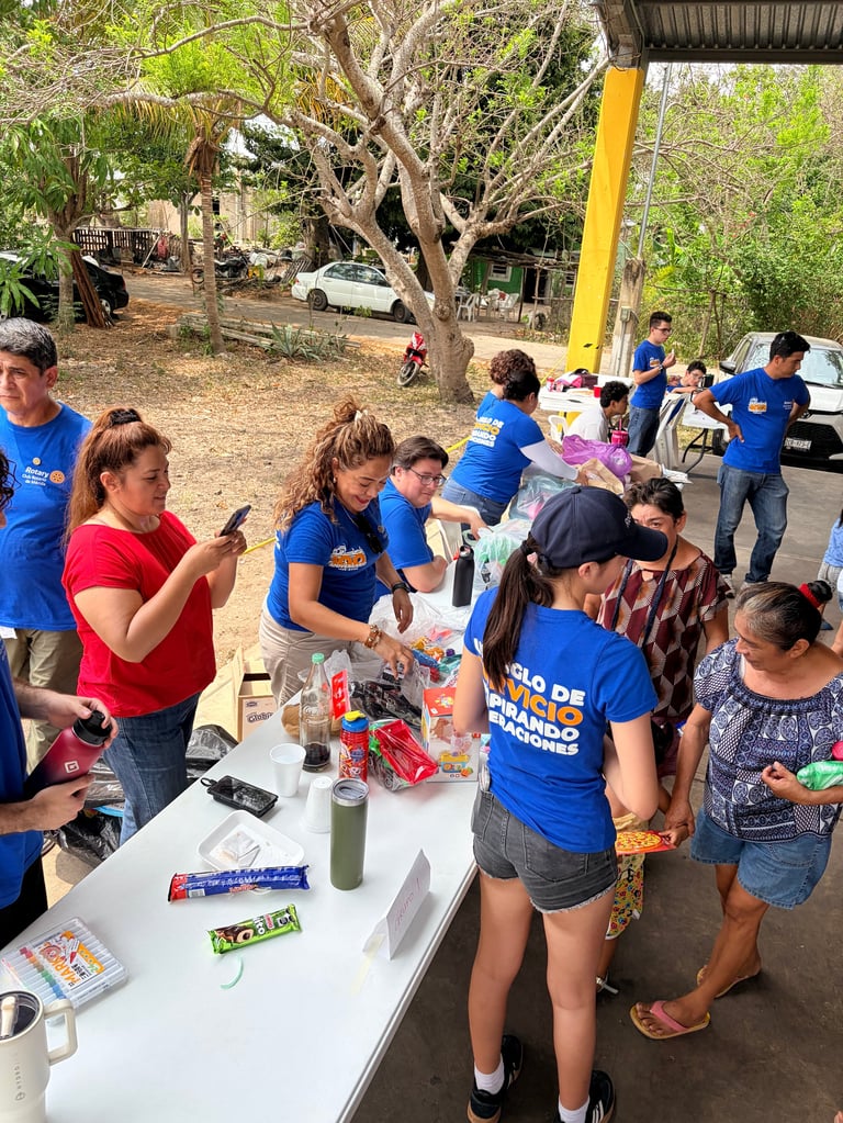Voluntarios y comunidad en la mesa de despensas durante la jornada