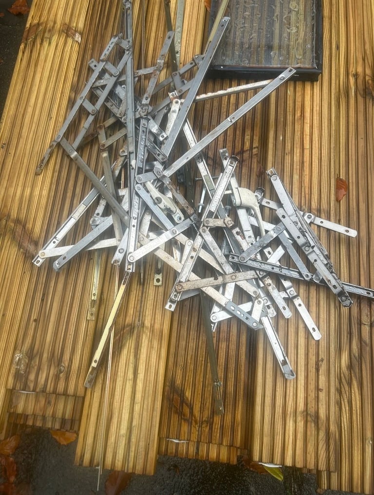 Pile of dismantled metal window frames and aluminum brackets