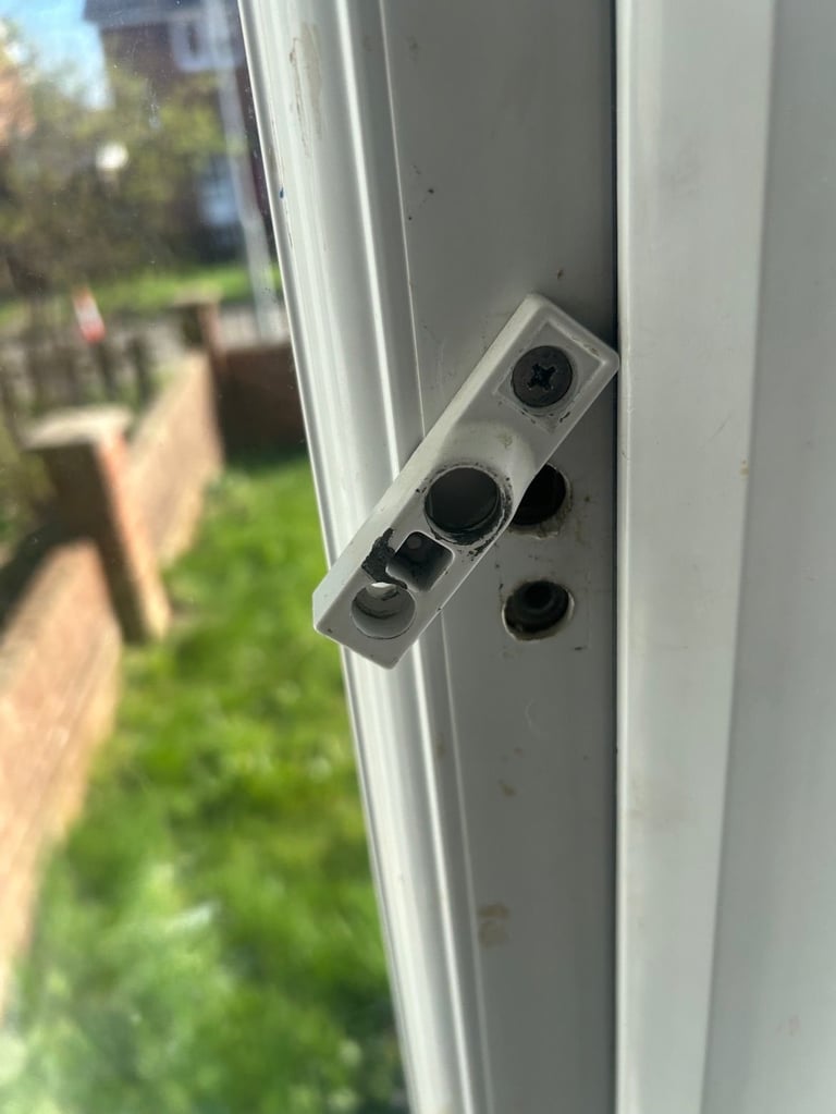 Close-up of a white security camera mounted on a door frame