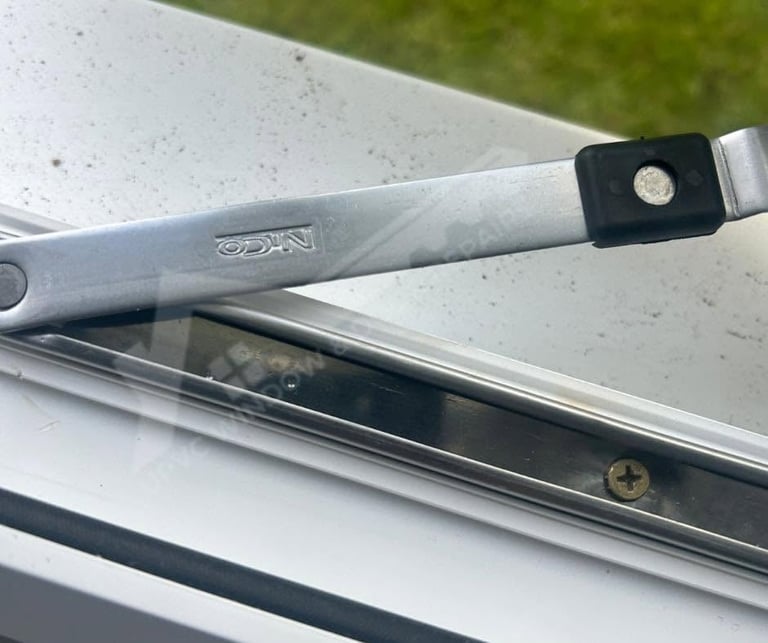 Close-up of a vehicle tonneau cover latch mechanism securing the aluminum frame to the truck bed