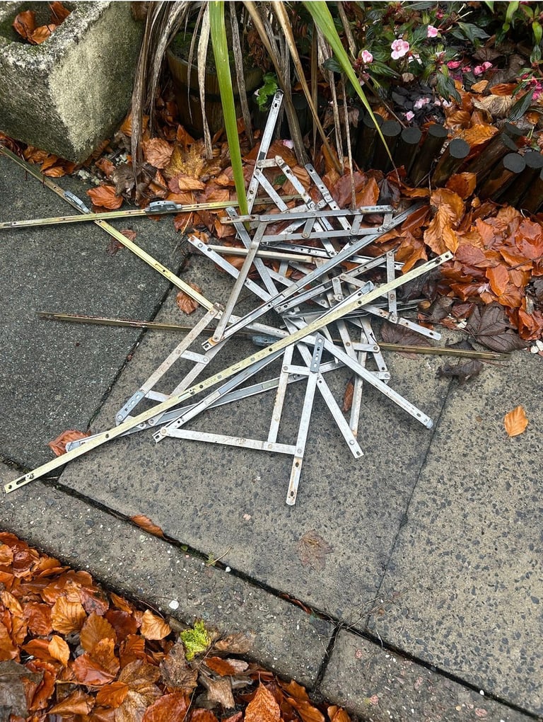 Pile of white plastic parts scattered on a gray paved surface