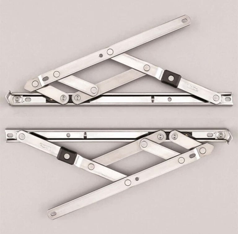 Two metal window sash hinges with connecting bars and pivot points
