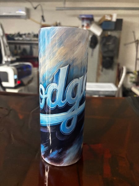 Tall drink can wrapped with a blue team design