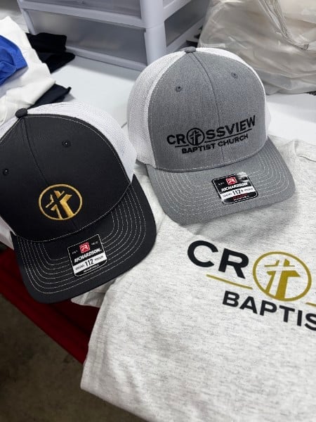 Two caps embroidered for a local church