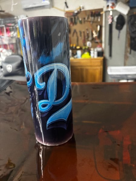 Custom wrapped drink tumbler with ornate swirling design