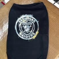 Black dog sweater printed with a football team logo