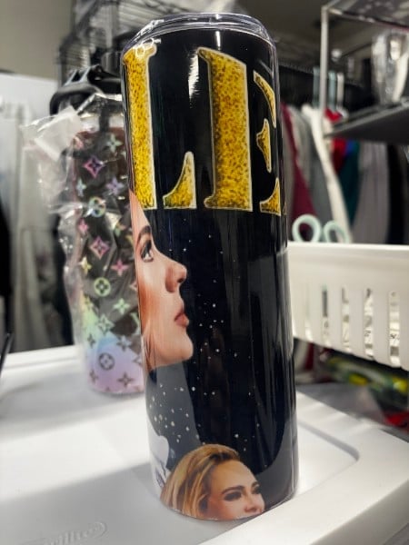 Black tumbler with gold lettering and portrait photos