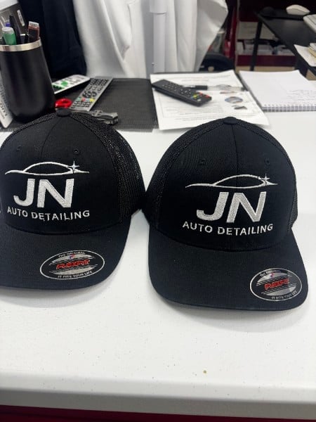 Black caps embroidered with auto detailing business logo
