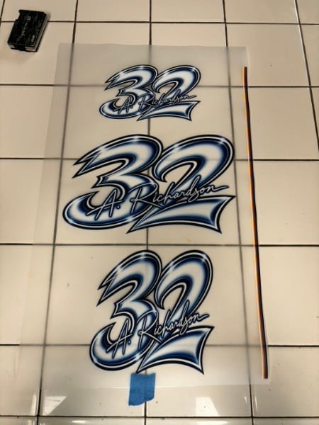 Three graffiti-style number 32 designs with blue and silver shading on white paper, arranged vertically for comparison or reference