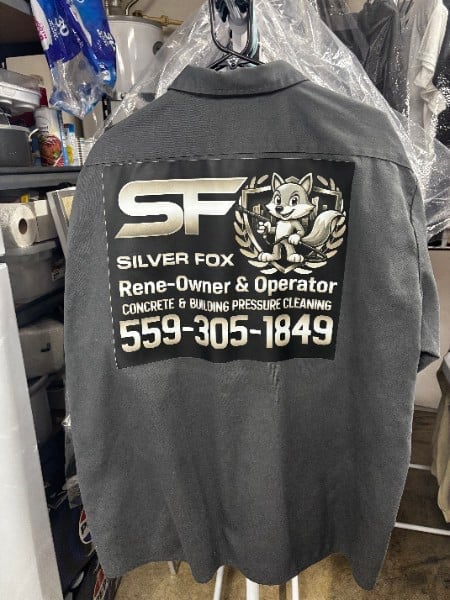 Dark gray work shirt printed with a pressure washing company logo