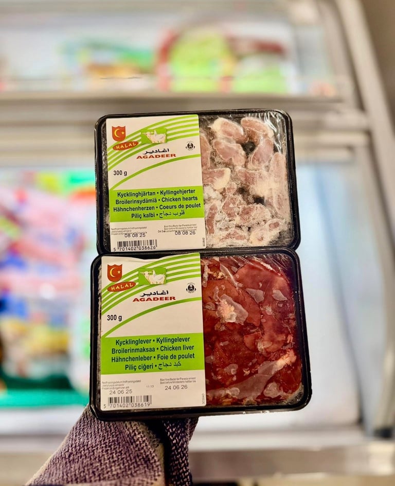 Hand holding packaged chicken liver and salami products at Asiatisk og Europeisk mat
