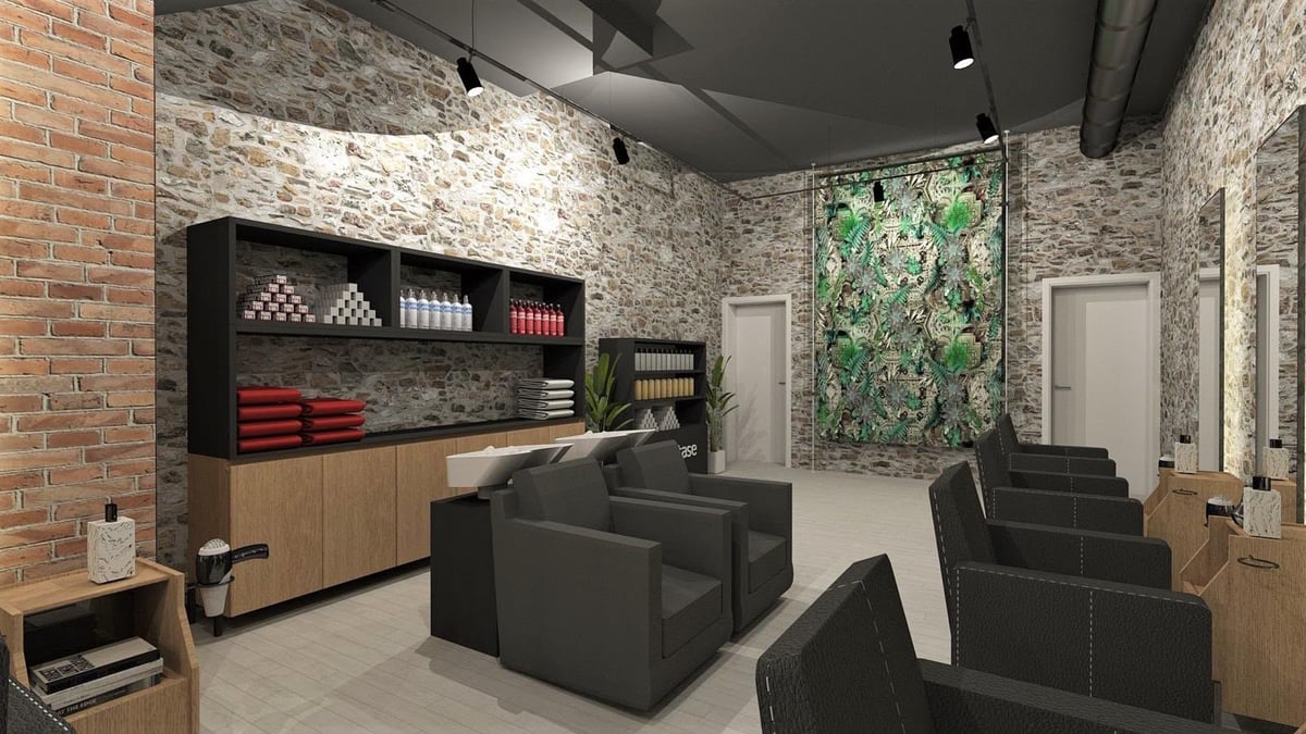 Modern office space with exposed brick walls, black furniture, wooden storage unit with red accent boxes, and green plant wall art