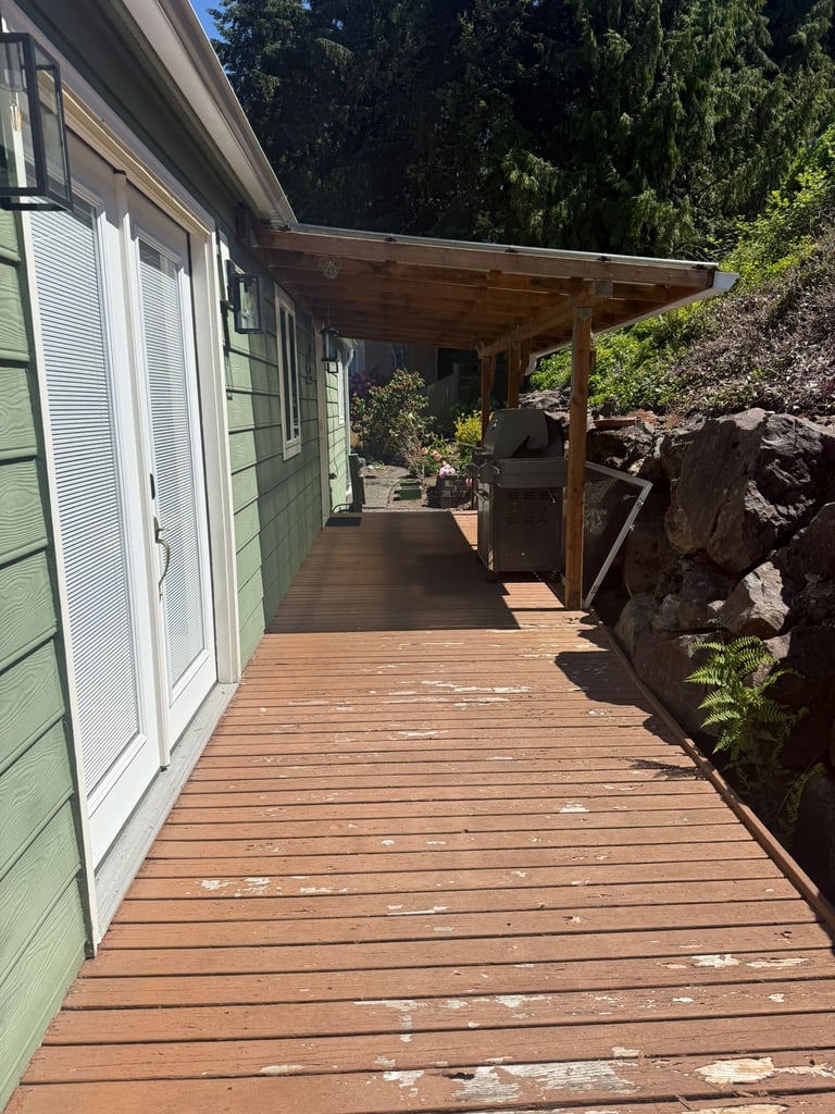 Long wooden deck with old pergola and peeling paint
