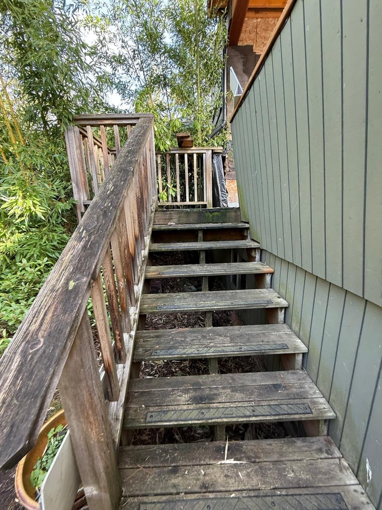 Weathered wooden exterior staircase before renovation