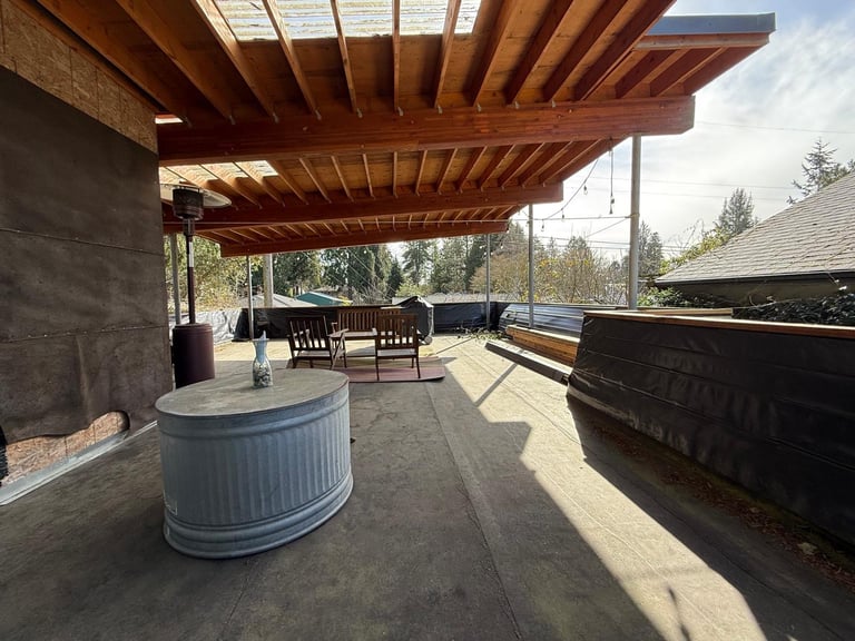 Modern outdoor patio with wooden pergola before renovation