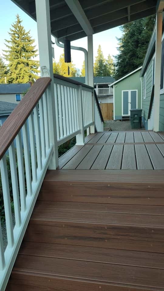 New composite deck with white railing under covered structure