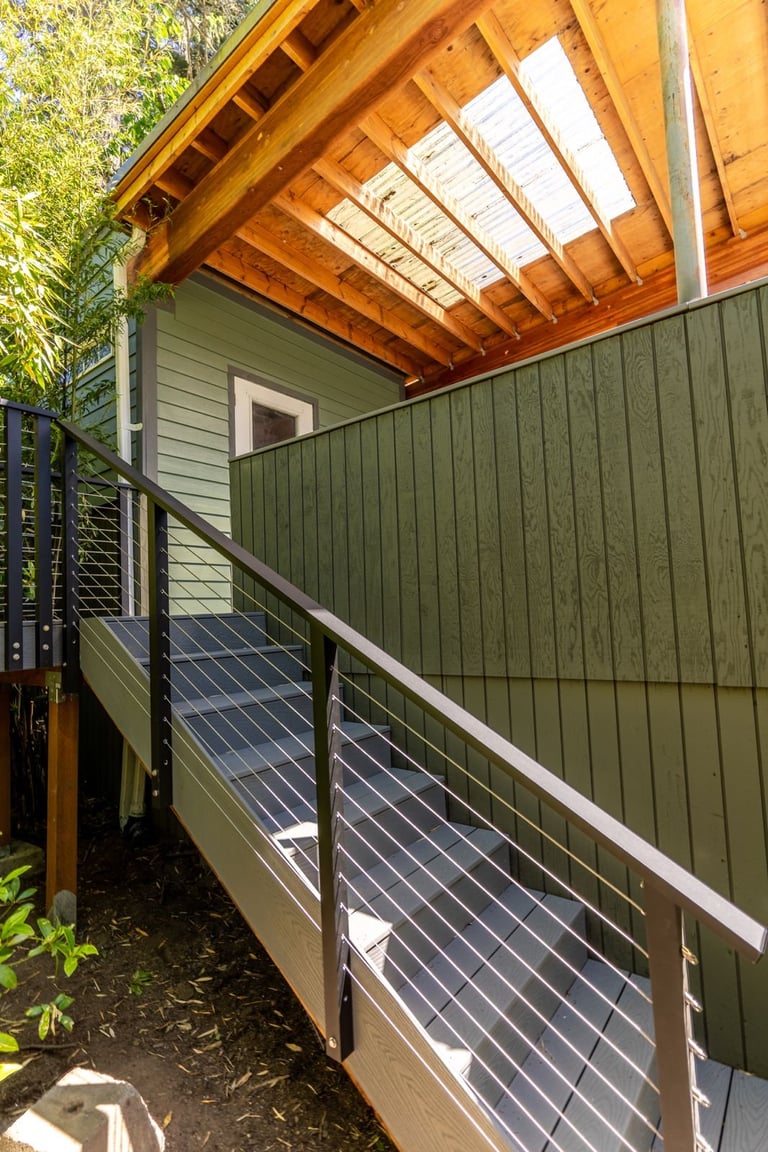 Modern wooden pergola with translucent roof and metal cable railing