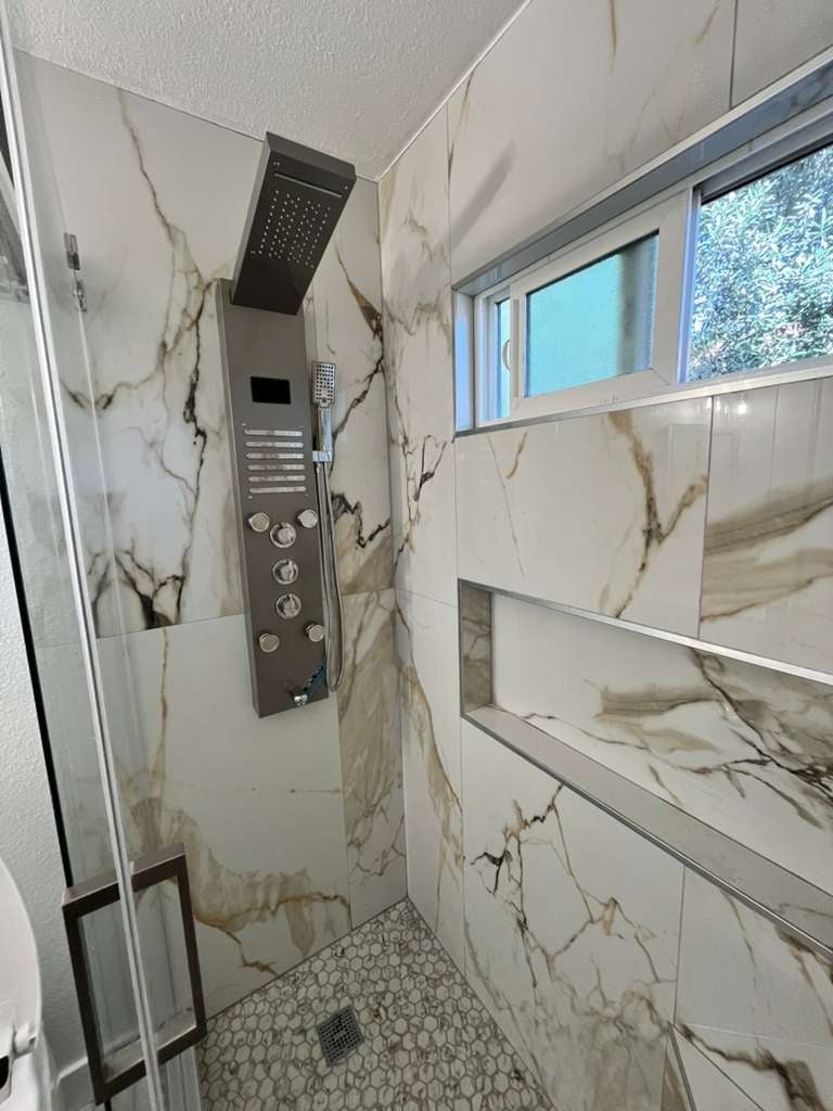 Modern shower with marble-effect tiles and rainfall showerhead
