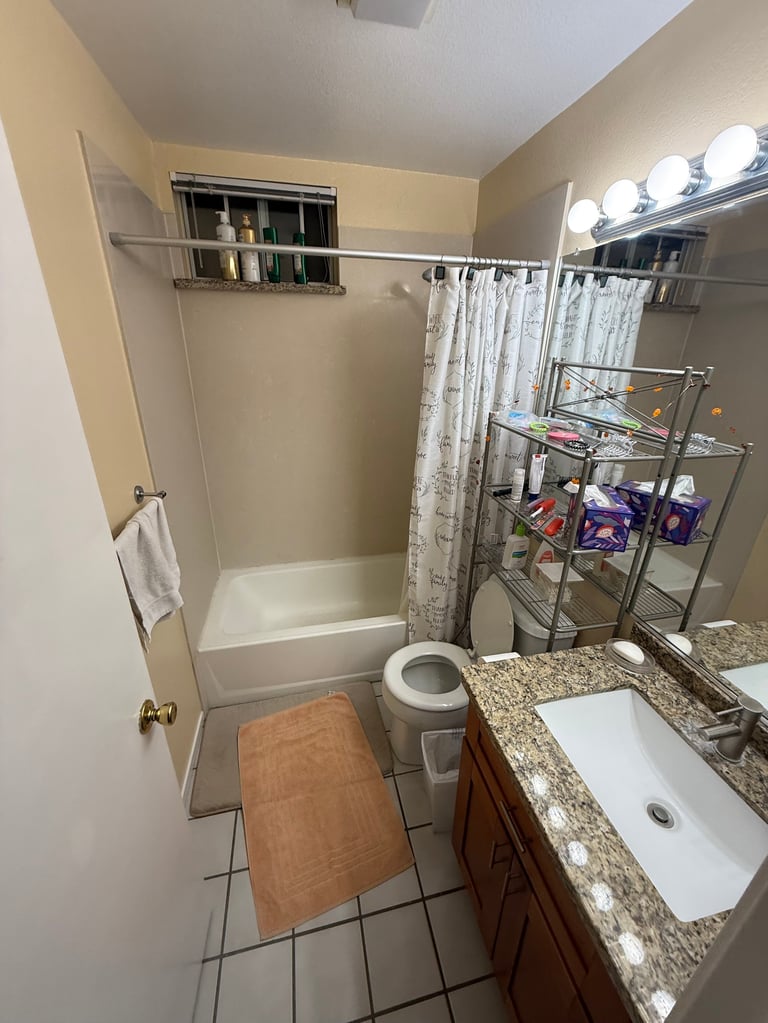 Dated bathroom with brown vanity and beige walls