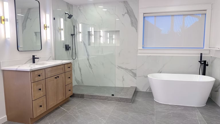 Modern bathroom with freestanding tub and frameless glass shower