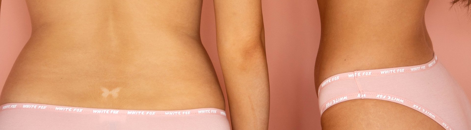 Close-up of three women wearing pink underwear, showing their torsos and midriffs against a pink background