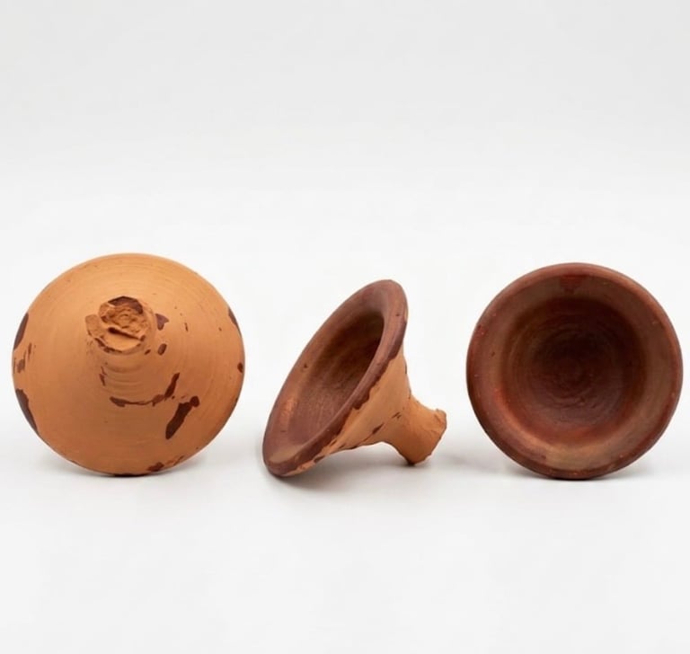 Three terracotta pottery pieces: a spherical vessel with carved face, a funnel-shaped object, and a bowl viewed from different angles