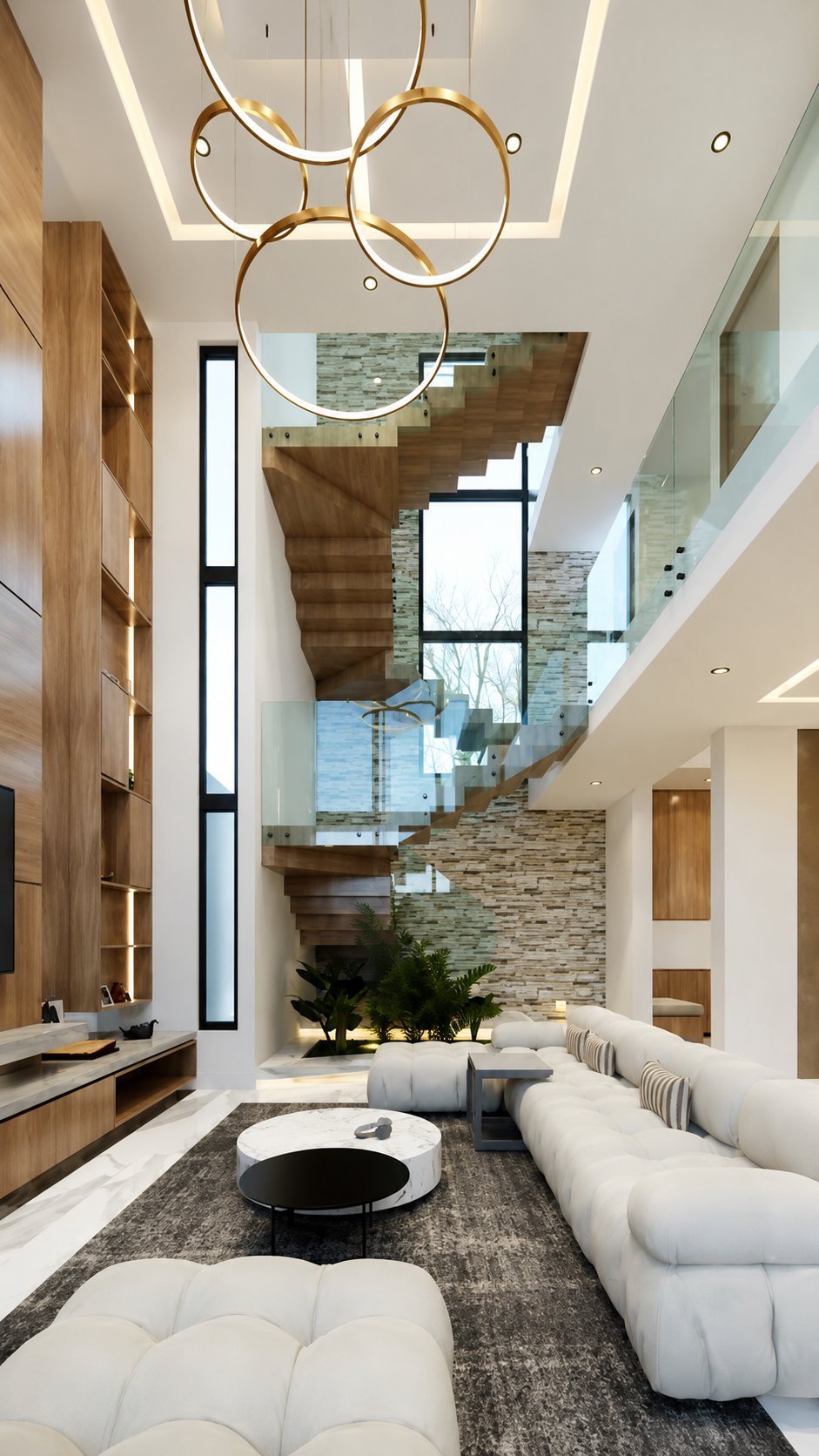 Modern luxury living room with high ceilings, sculptural gold pendant light, white curved sofa, wooden stairs, and stone accent wall