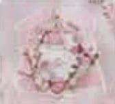 Pink baby shower invitation design with decorative wreath and gifts