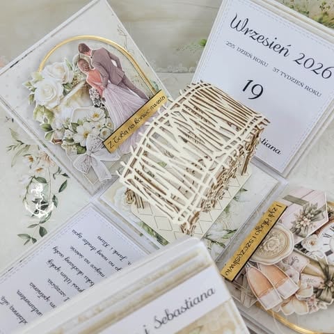 Elegant wedding invitation set with couple photo, woven basket detail, date card showing September 19, dried florals, and decorative elements in ivory and gold tones