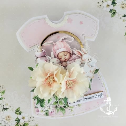 Baby girl greeting card shaped like a onesie with photo of sleeping infant, cream flowers, and text that reads Cutest Swiety Zuya