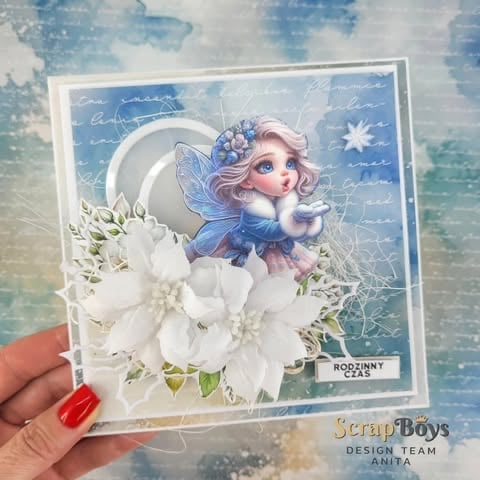 Handmade greeting card featuring a fairy with pink hair in a crescent moon against blue night sky background with white flower embellishments