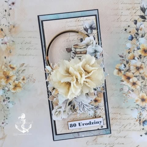 Handmade birthday card with cream carnation 3D flower, vintage script background, gold rings, blue frame, and '40 Urodziny' Polish text