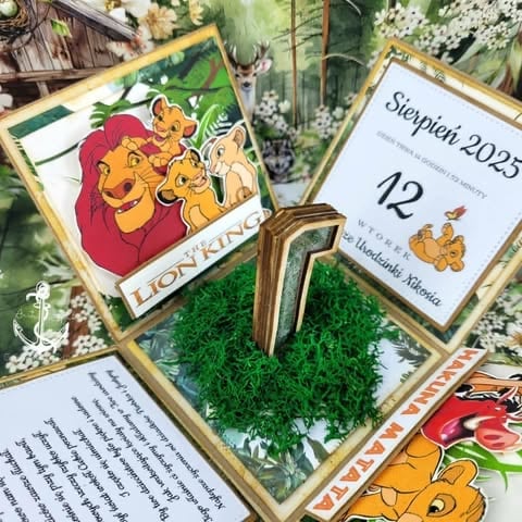 Lion King themed party display with framed character art, calendar showing August 12, 2025, and moss centerpiece with gold frame accents