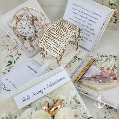 Flat lay of wedding invitation suite with decorative clock, woven basket, florals, guest card, and gold pen on white background