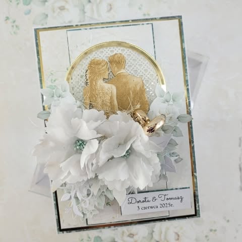 Handmade wedding card with two gold silhouettes, white 3D peonies, gold rings, and 'Dorota & Tomasz 3 czerwca 2025r.' text