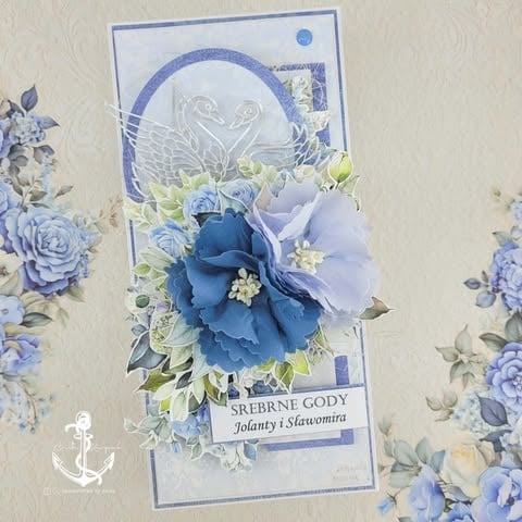Handmade greeting card with blue and white floral design, featuring layered blue and lavender flowers and greenery on decorative cardstock