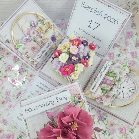 Flat lay of wedding planning materials with pink and white flowers, calendar showing September 17 2026, and floral fabric background