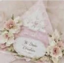 Elegant floral wedding invitation with cream roses and soft pink ribbon