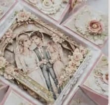 Ornate decorative box with floral designs and lace details, vintage aesthetic